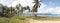 Tropical palm trees and ocean landscape at Las Galeras Beach in the SamanÃ¡ Bay of Caribbean Dominican Republic.