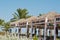 Tropical pavillion on the beach background palms