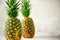 Tropical pineapples on gray background. Summer, holiday concept. Raw, vegan, vegetarian, clean eating diet. Close up of