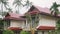 Tropical rain drops falling on the palm leaves in island Koh Samui, Thailand. Changes focus to beautiful house from rain