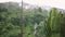 Tropical rain drops falling on palm trees changes focus to mountains with beautiful villas in island Koh Samui, Thailand