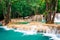 Tropical rain forest jangles with Kuang Si waterfall. Laos