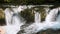 Tropical rainforest, illuminating trees in mountain jungle, river with waterfall. Canyon Martvili in Georgia