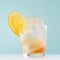 Tropical refreshing fruit drink with slices oranges, ice in misted shot glass on white wood board, pastel green interior, square.