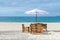 Tropical resort view with beach table, chairs and umbrella