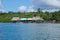 Tropical restaurant over the sea with boat at dock