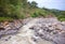 Tropical river panorama. Tropical landscape. Fresh river in stone riverbed.