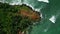 Tropical rocky island in the sea washed by waves aerial view. Famous landmark Coconut Hill in Mirissa, Sri Lanka washed