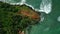 Tropical rocky island in the sea washed by waves aerial view. Famous landmark Coconut Hill in Mirissa, Sri Lanka washed