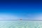 Tropical sandbank island with sunshade umbrella. Indian Ocean, Maldives.