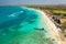 Tropical sandy exotic emerald paradise beach with sunbeds and sun umbrellas aerial view