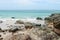 Tropical sandy rocky beach with clear clear blue water