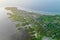 Tropical sea coast-boats, local huts, palm trees. Aerial view from the drone