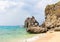 Tropical seaside scene with mountain. Aqua blue sea water and white sand beach.