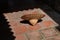 Tropical straw hat on a terracotta tile floor.