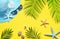 Tropical summer beach background. Palm trees branches, hat with starfish on yellow summer background. Travel. Summer