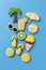 Tropical summer beach refreshment decorated cookies, palm tree, sunshade, pool-beach ball, slippers, ice cream, citrus fruit, blue