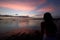 tropical sunset in raja ampat archipelago with young woman silhouette sitting
