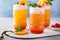 Tropical tiki cocktail with cold foam, garnished with orange slices, cherry and mint