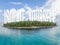 Tropical uninhabited island atoll covered with a lash coconut forest with a sign `isolate yourself`