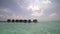 Tropical vacation, water bungalow cottage in ocean water on exotic resort