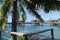 Tropical water huts, bungalows in Bora Bora Tahiti idyllic honeymoon vacation with palm tree leaves