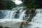 Tropical waterfall, swimming boys.