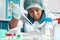 Troubleshooting of nucleic acid tests. African scientist, technical assistant or graduate in lab coat, protective hat and gloves