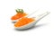 Trout eggs in a white ceramic spoon on white background