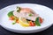 Trout salmon with vegetables, lemon and microgreens, cooked by the confit method. Traditional French dish. Step by step.