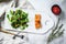 Trout steak with arugula, lettuce and cranberries. Gray background. Top view