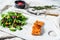 Trout steak with arugula, lettuce and cranberries. Gray background. Top view