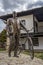 TROYAN, BULGARIA - March 2, 2020:StatuÐµ of man with bicycle in front of traditional Bulgarian house near the Museum of Folk Arts