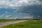 Truck approaching with looming storm clouds, Saskatchewan, Canad