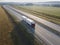 Truck with Cargo Semi Trailer Moving on Summer Road. Aerial Top View. White vehicle