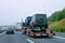 Truck carrier with cars on asphalt road of Slovenia