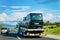 Truck carrier with mini vans on asphalt road in Slovenia