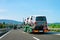 Truck carrier with mini vans in asphalt road in Slovenia