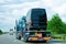Truck carrier with mini vans in asphalt road of Slovenia