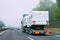 Truck carrier with motor homes rv on asphalt road of Slovenia