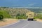 The truck carries rolls of hay. Ivanovka mounatain village of Ismailli region of Azerbaijan. Village life.