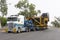 Truck carrying monster mining dump truck chassis for Adani