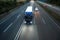 Truck and cars speeding on a highway in the evening