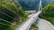 Truck crosses beautiful bridge in summer. Scene. Top view of truck carrying things driving across bridge on background