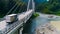 Truck crosses beautiful bridge in summer. Scene. Top view of truck carrying things driving across bridge on background