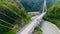 Truck crosses beautiful bridge in summer. Scene. Top view of truck carrying things driving across bridge on background