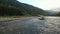 A truck crosses a mountain river