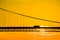 Truck crossing hanging bridge at sunset