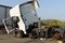 A truck damaged in an accident parked in a parking lot