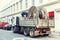 Truck delivering heavy supply electric cable reel at city street